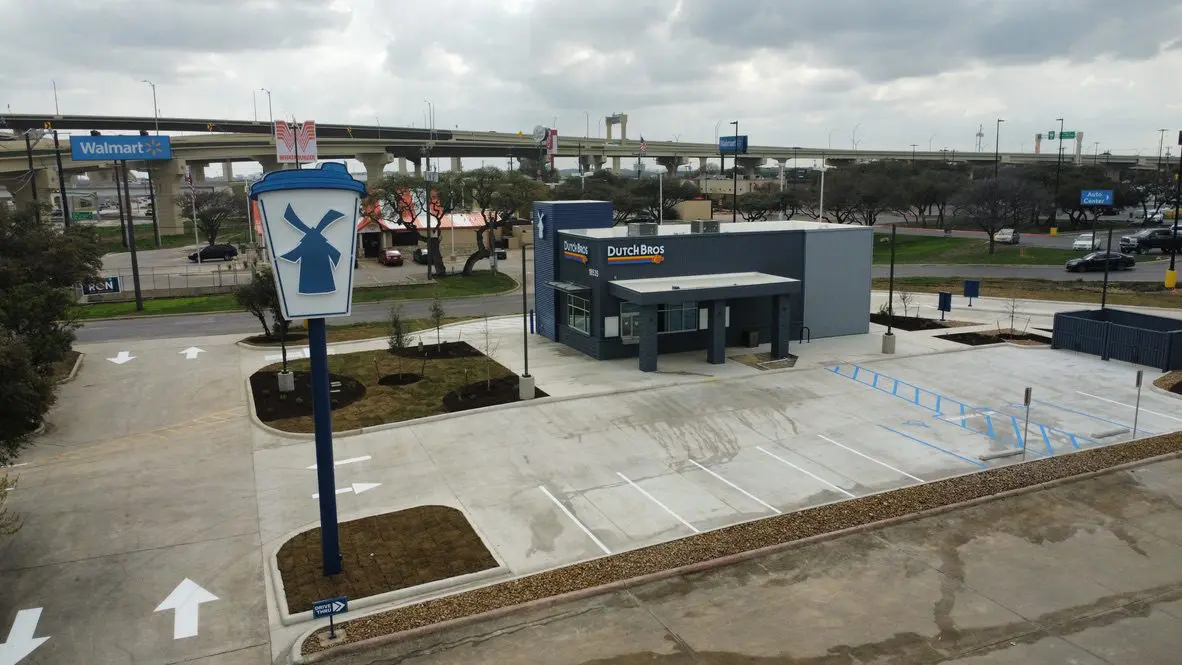 Drive-thru coffee shop with parking lot.