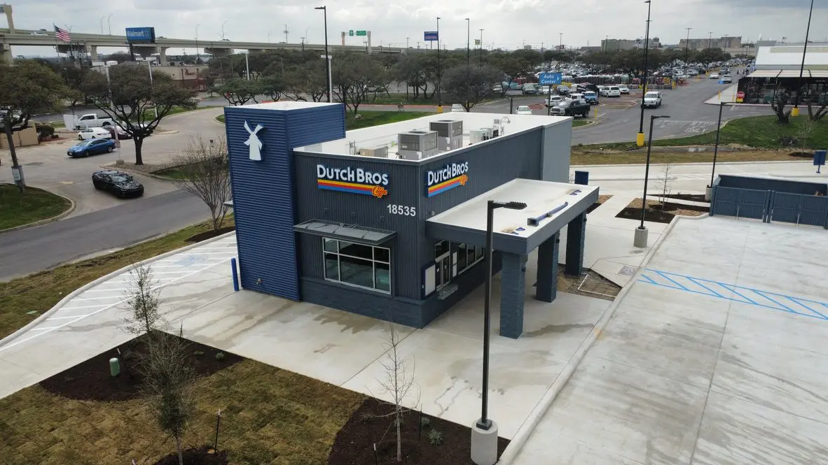 Drive-thru coffee shop with surrounding parking lot.