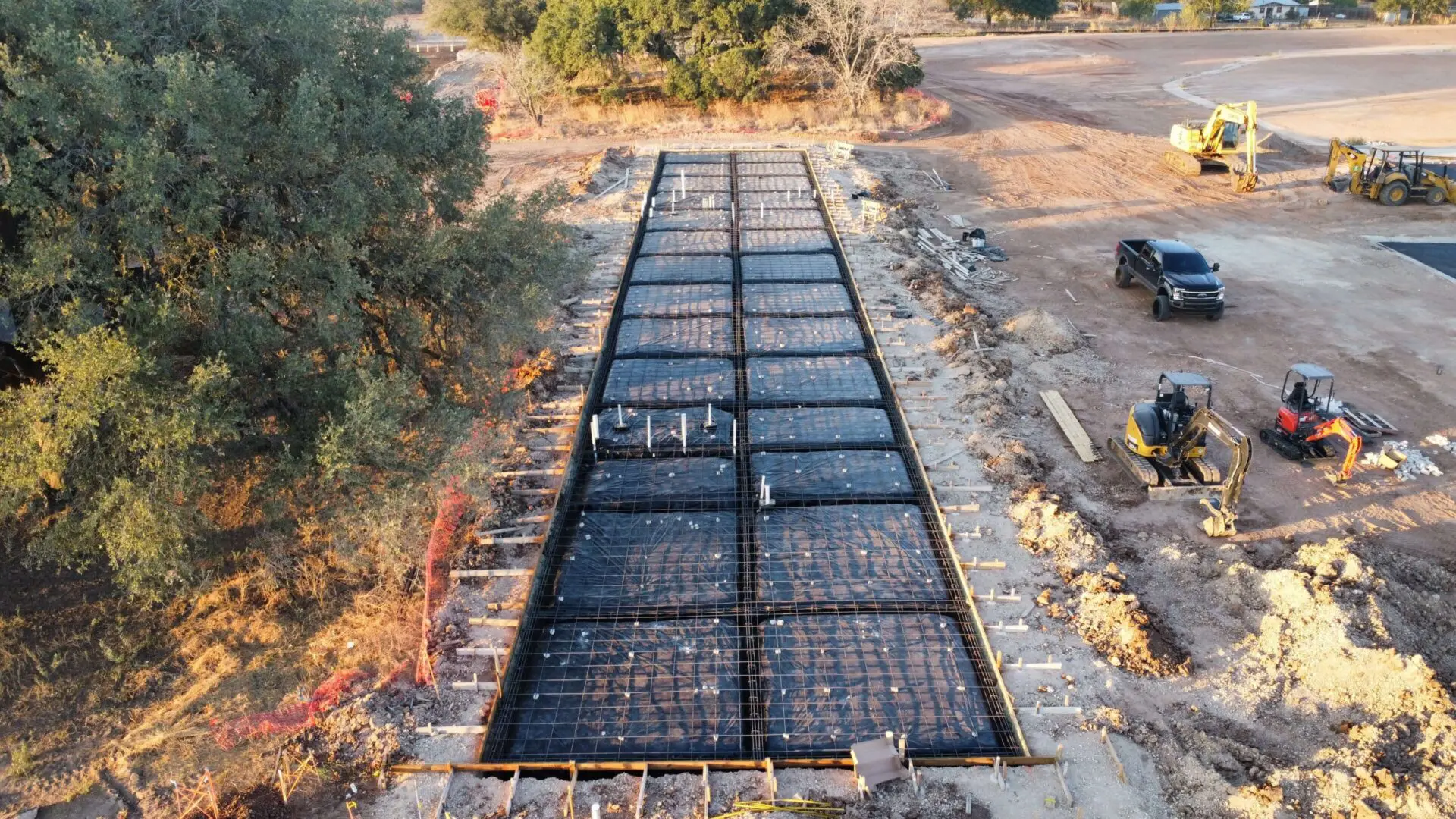 Construction site with heavy machinery and framework.