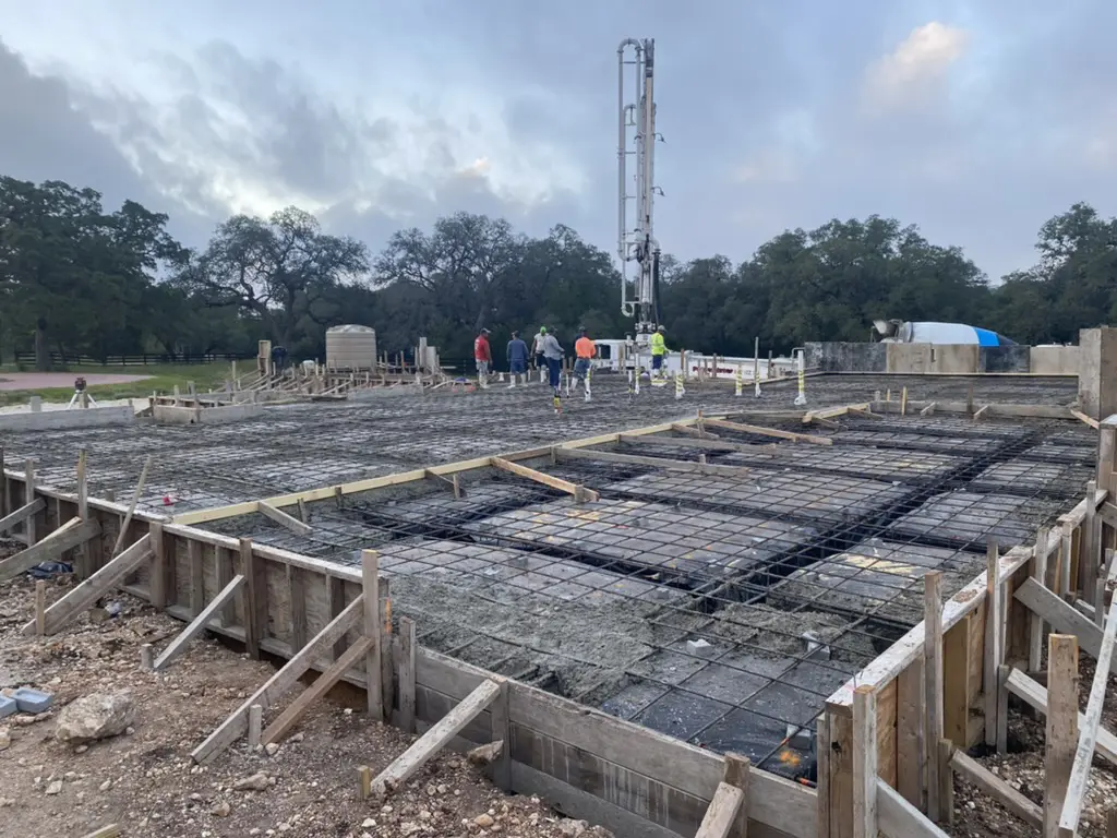 Construction site with rebar and workers.