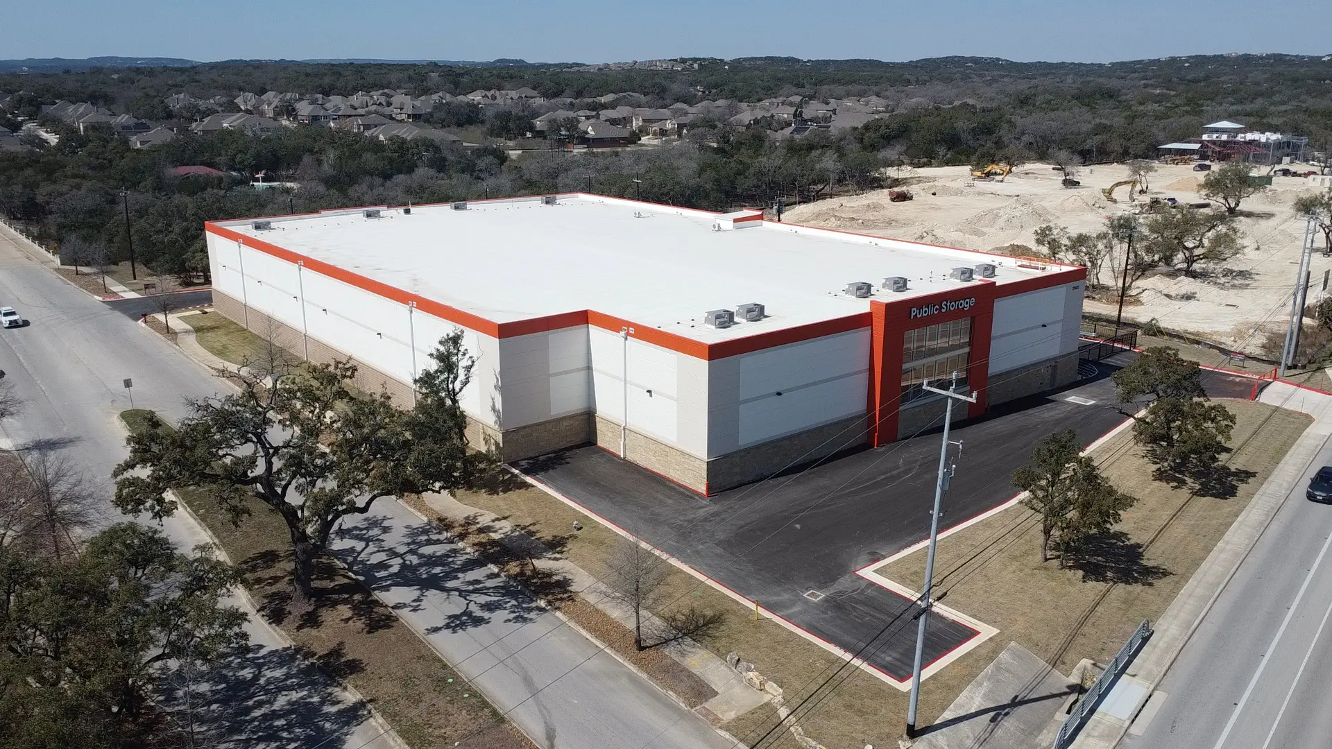 Large warehouse building with red accents.