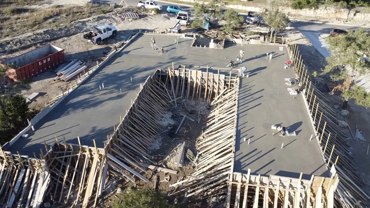 Construction site with concrete foundation and forms.