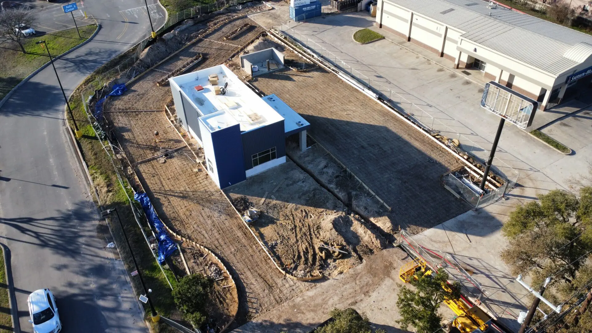 Aerial view of construction site with building.