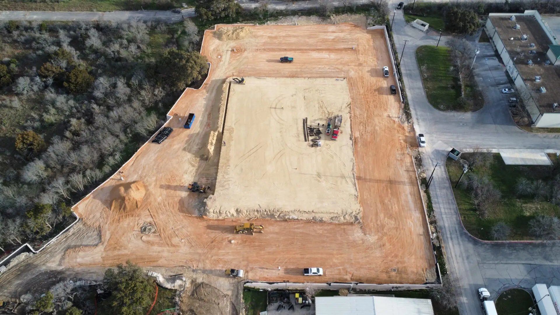 Construction site with vehicles and equipment.